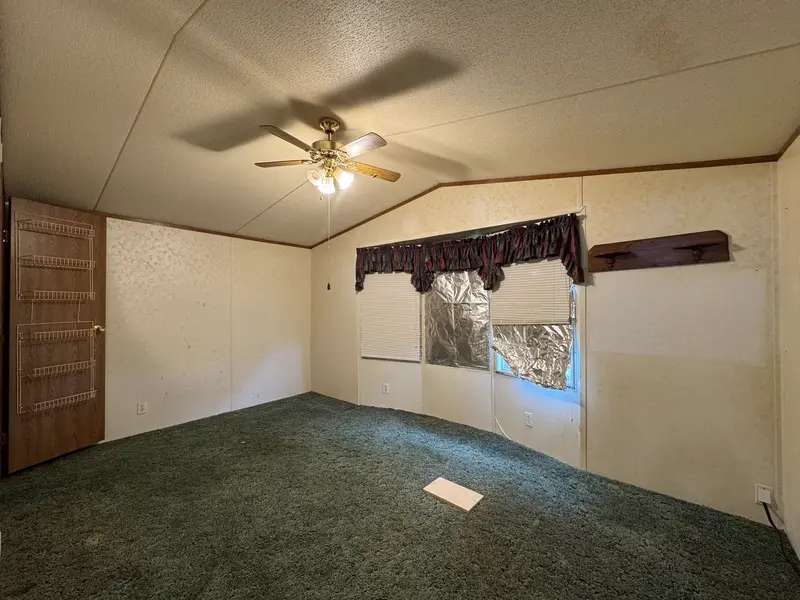 Living room with vaulted ceiling and natural light