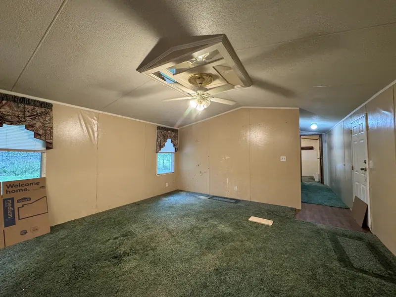 Spacious living room with ceiling fan
