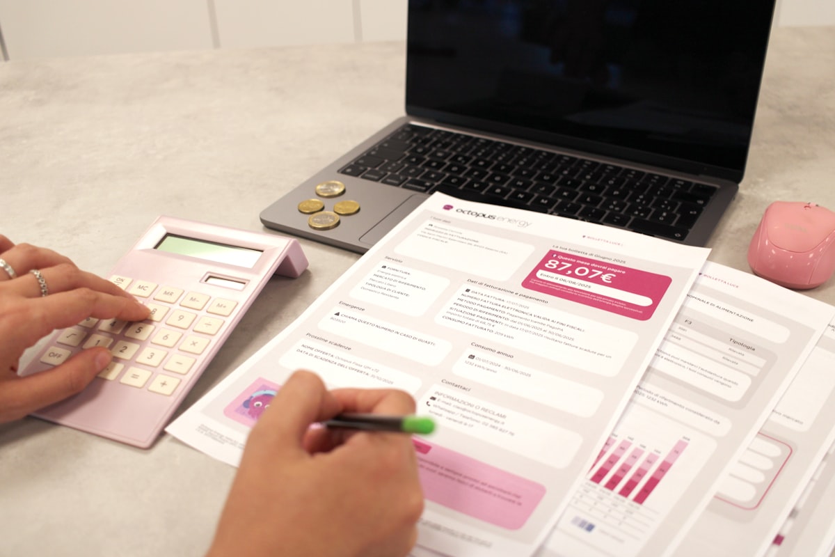 Person calculating finances and reviewing property documents during divorce